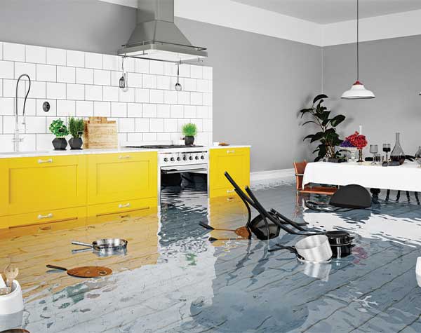 Flooded kitchen with yellow cabinets and floating utensils