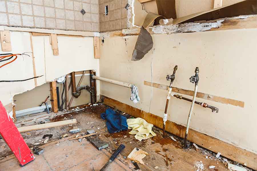 Water Damage Restoration Kitchen under renovation with exposed pipes